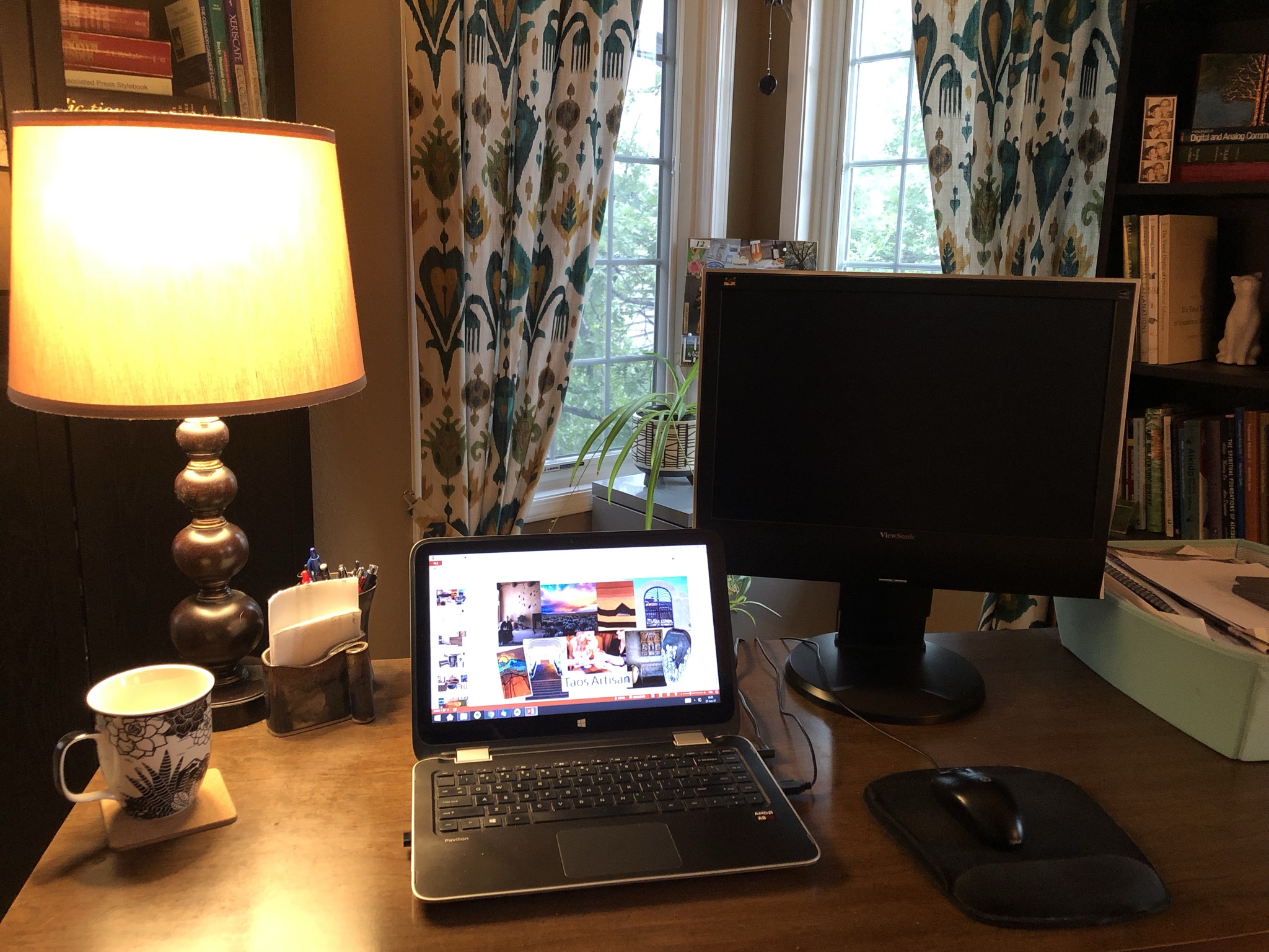 desk in home office with laptop